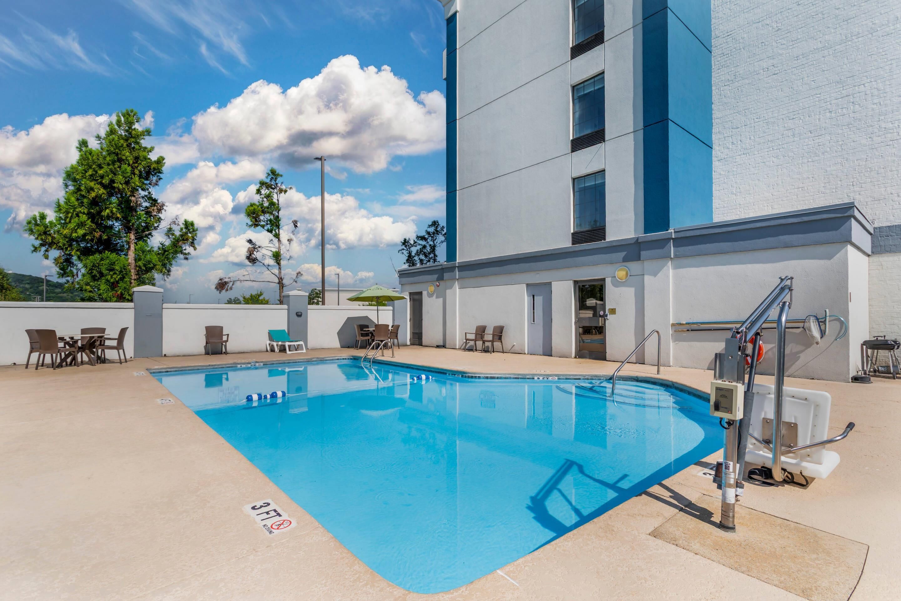 seasonal outdoor pool, open 9 am to 10 pm, pool umbrellas, pool loungers