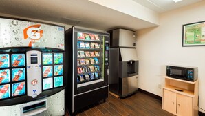 A kitchenette with a refrigerator, microwave, and vending machines. - Red Roof Inn Rockford East – Casino District (Rockford)