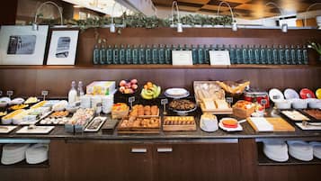 A buffet with various food items and beverages.