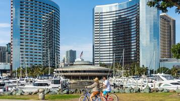 A marina with boats and a large building with a curved facade.