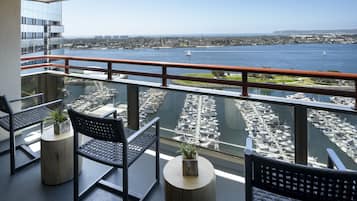 A balcony with a view of a marina and cityscape.