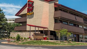 A hotel with a sign reading 'Red Roof Inn'.
