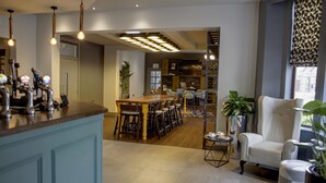 A modern kitchen with a central island, bar area with taps, and seating. - Best Western Plus Nottingham Westminster Hotel (Nottingham)