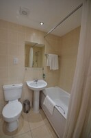 A bathroom with a toilet, sink, and bathtub.