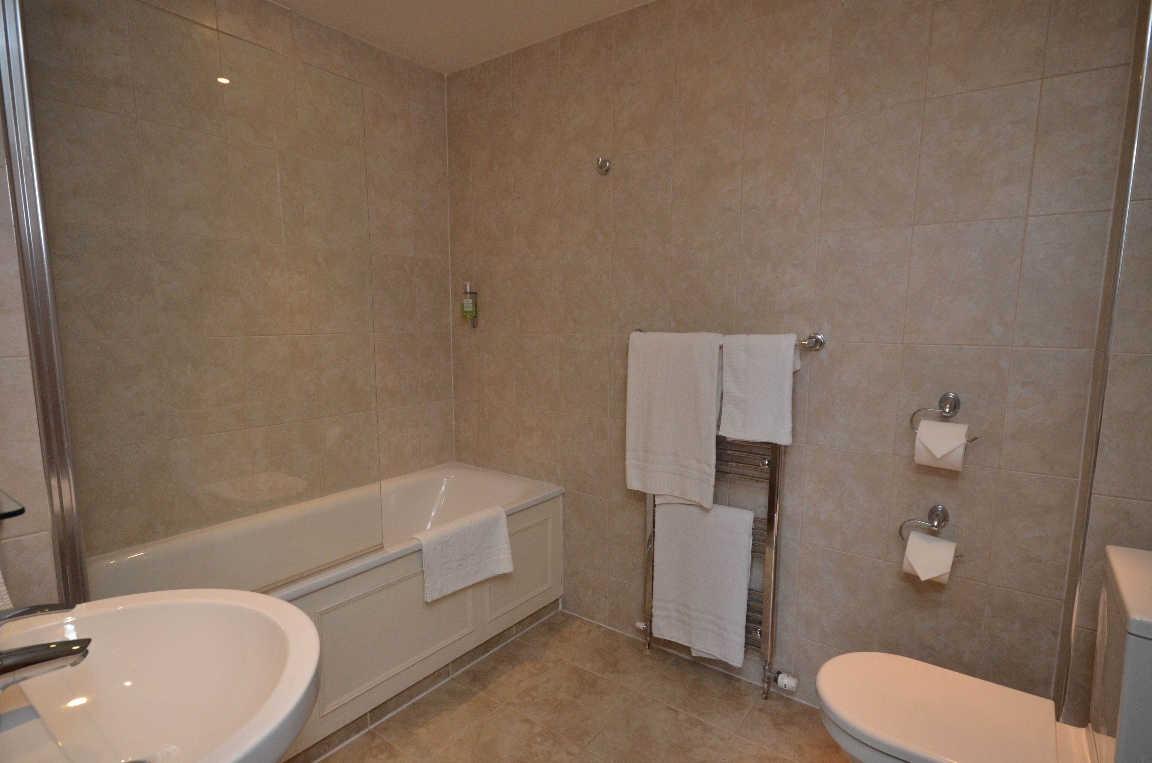 A bathroom with a bathtub, a sink, and a toilet.