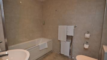 A bathroom with a bathtub, a sink, and a toilet.