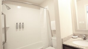 A bathroom with a shower, toilet, and sink.
