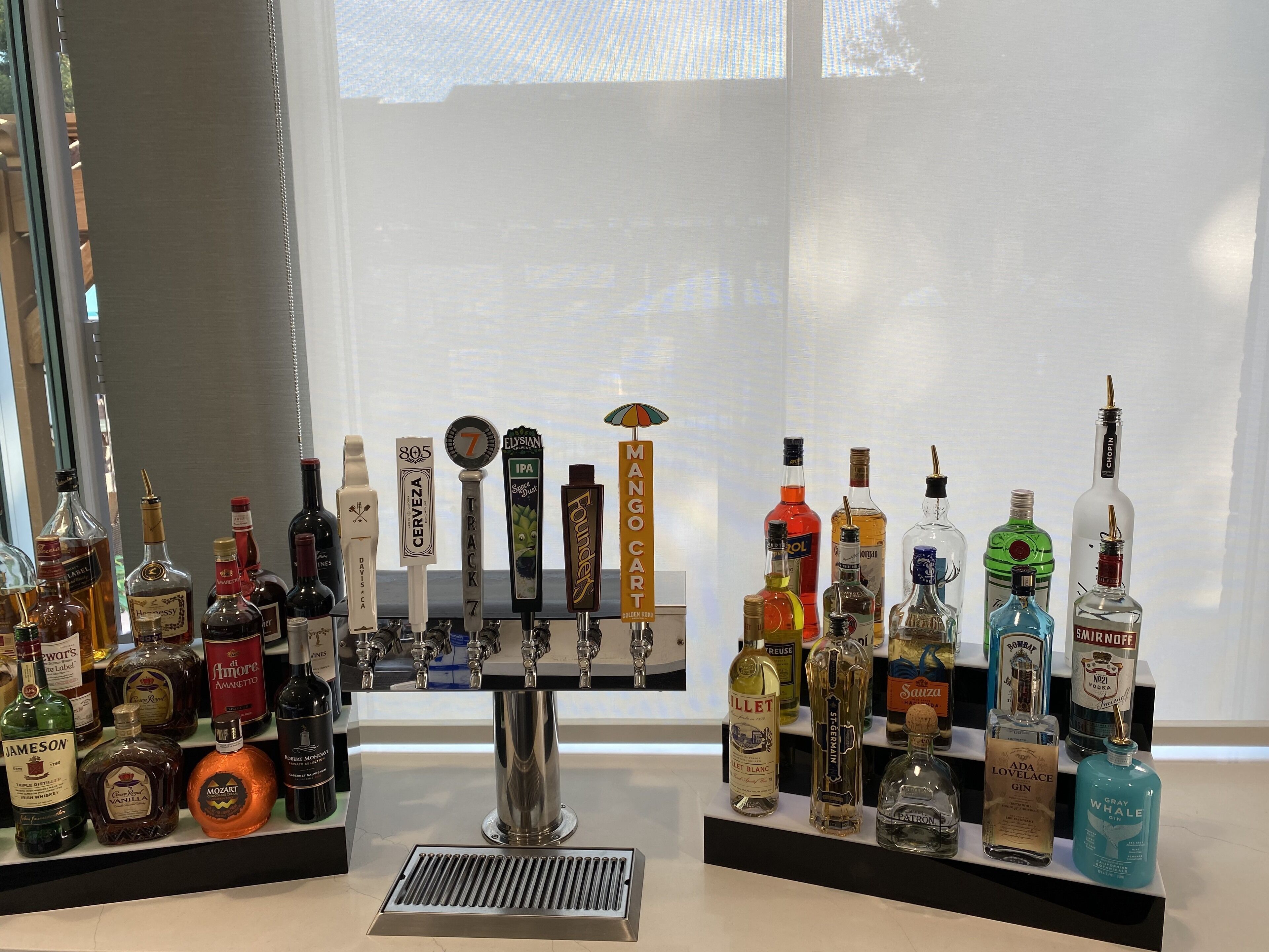 A bar area with various liquor bottles and a tap system.