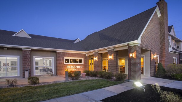 A brick building with a 'Residence Inn' sign, large windows, and a well-maintained lawn. - Residence Inn by Marriott Topeka (Topeka)