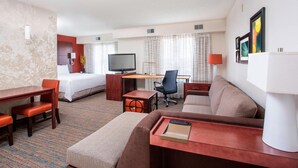 A hotel room with a bed, a desk, a sofa, and a television. - Residence Inn by Marriott Topeka (Topeka)