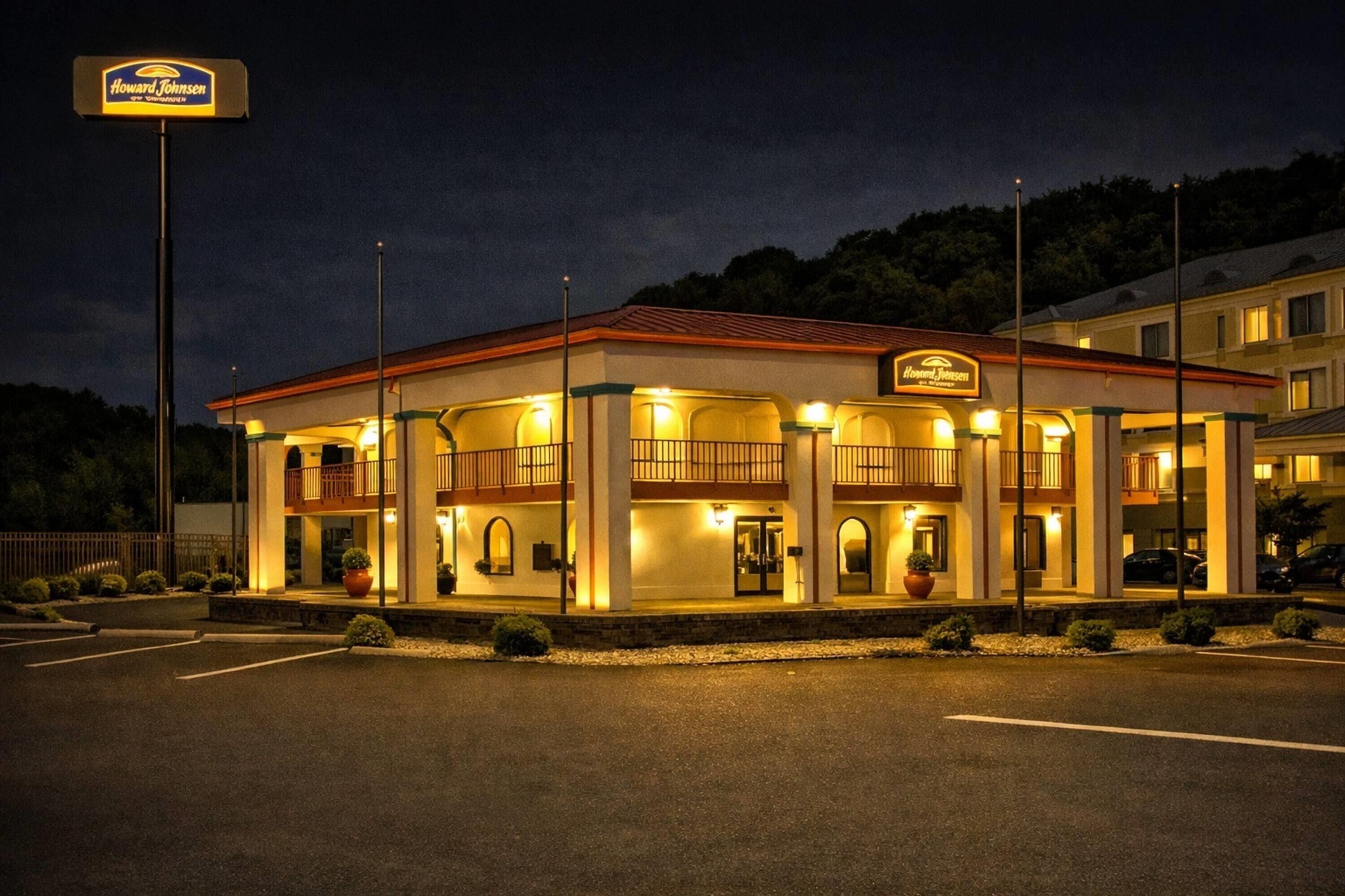A Howard Johnson's motel with a two-story structure, multiple balconies, and a parking lot.