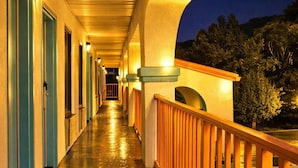 A hotel corridor with doors, a wooden railing, and a night sky. - Howard Johnson by Wyndham Chattanooga Lookout Mountain I-24 (Chattanooga)
