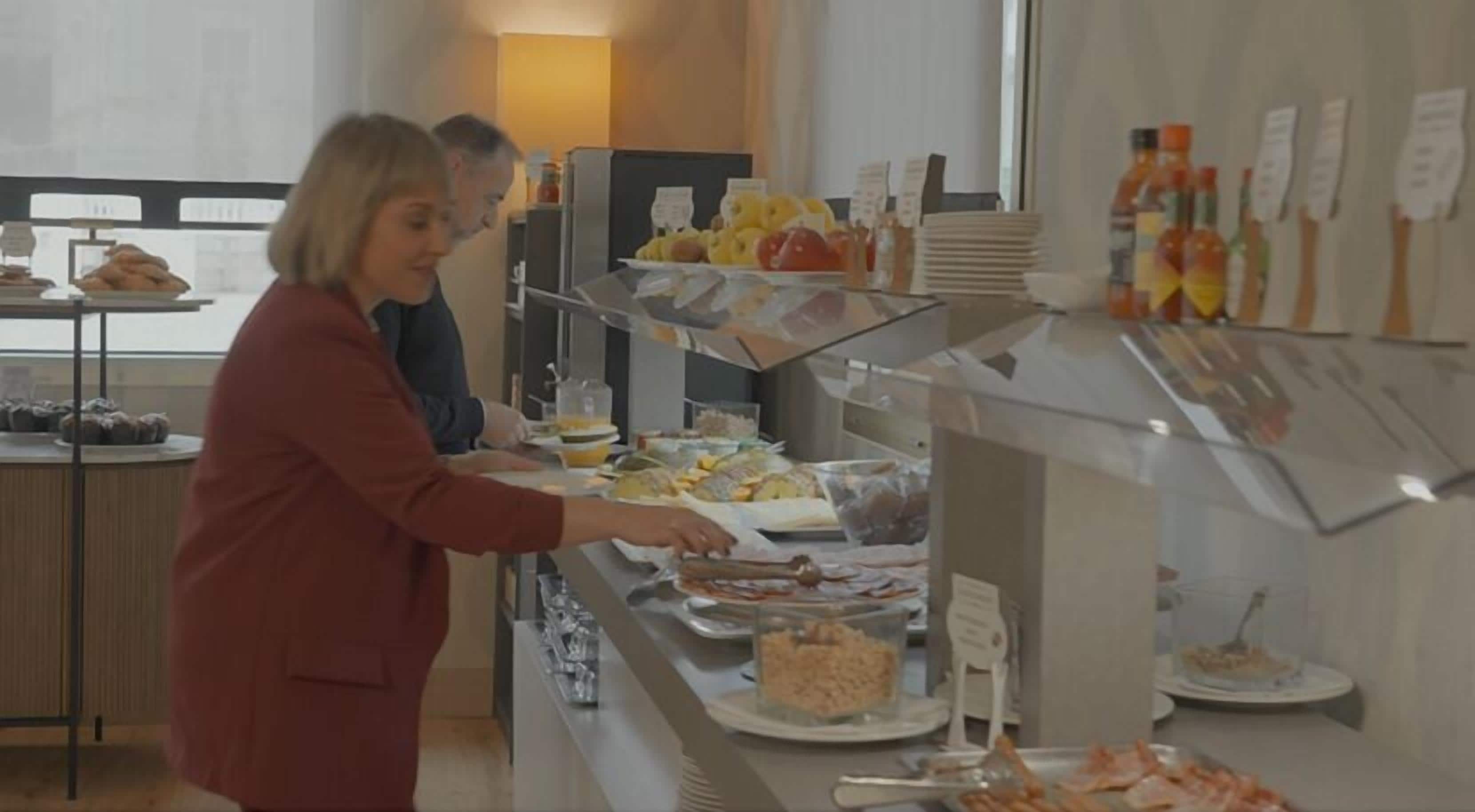 A buffet setup with various food items and condiments.
