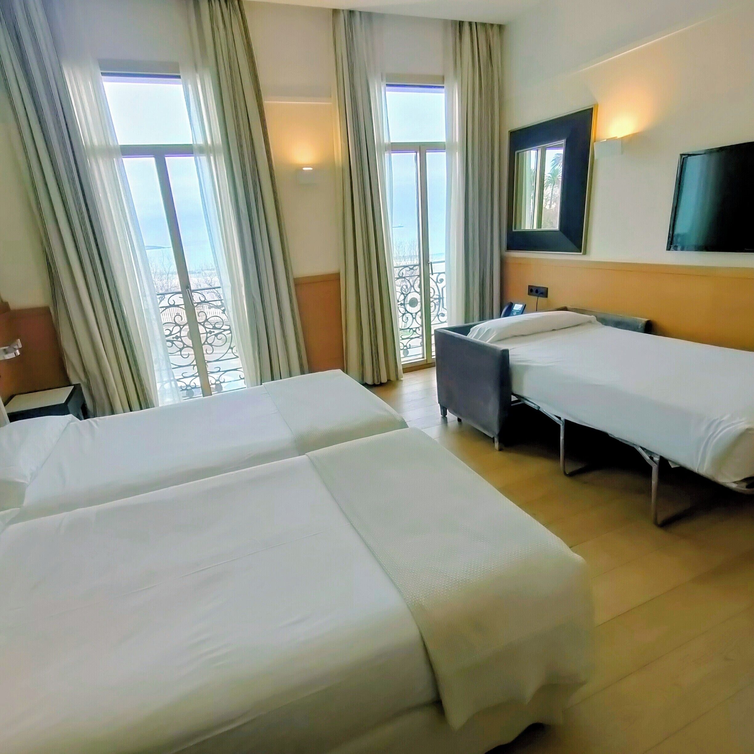 Standard Triple Room, Ocean View | Minibar, in-room safe, desk, laptop workspace