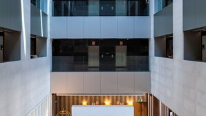 A multi-level atrium with a central seating area, large windows, and modern furnishings. - Gran Hotel Sardinero (Santander)