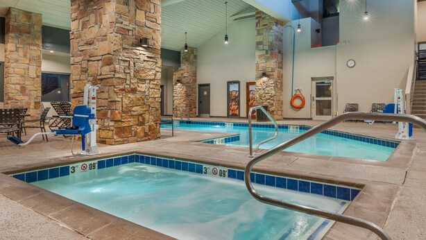 An indoor swimming pool with stone pillars, a lifeguard chair, and a clock on the wall. - Hilton Vacation Club Cedar Breaks Brian Head (Brian Head)