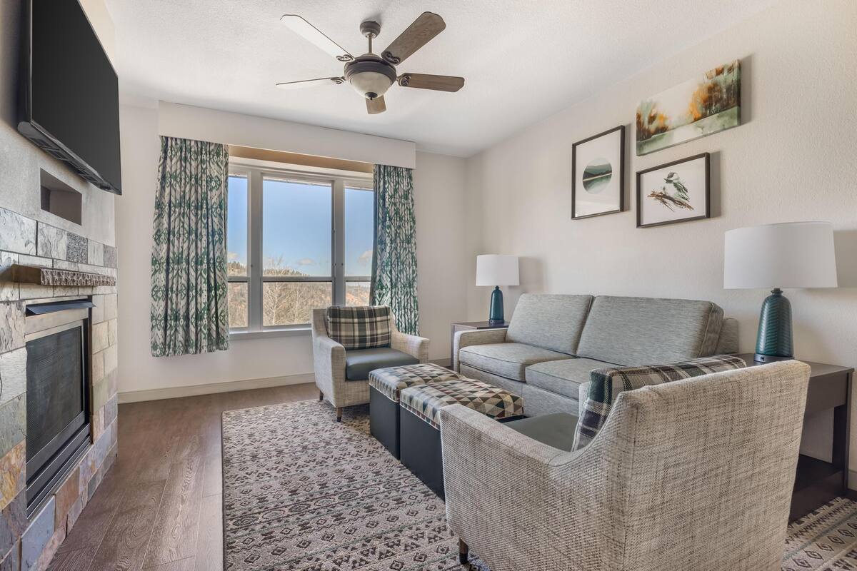 1 Bedroom 1 King or 2 Queens Suite Plus | Living area | TV, fireplace, DVD player, table football