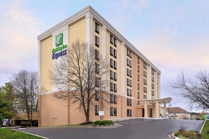 A Holiday Inn Express building with a flat facade, multiple windows, and a covered entrance.
