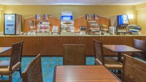 A hotel dining area with a self-service breakfast bar, seating arrangements, and a sign indicating a room for express service. - Holiday Inn Express Hunt Valley by IHG (Hunt Valley)