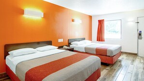 A hotel room with two beds, orange walls, a window with curtains, and a door with a lock. - Motel 6 Starke, FL (Starke)