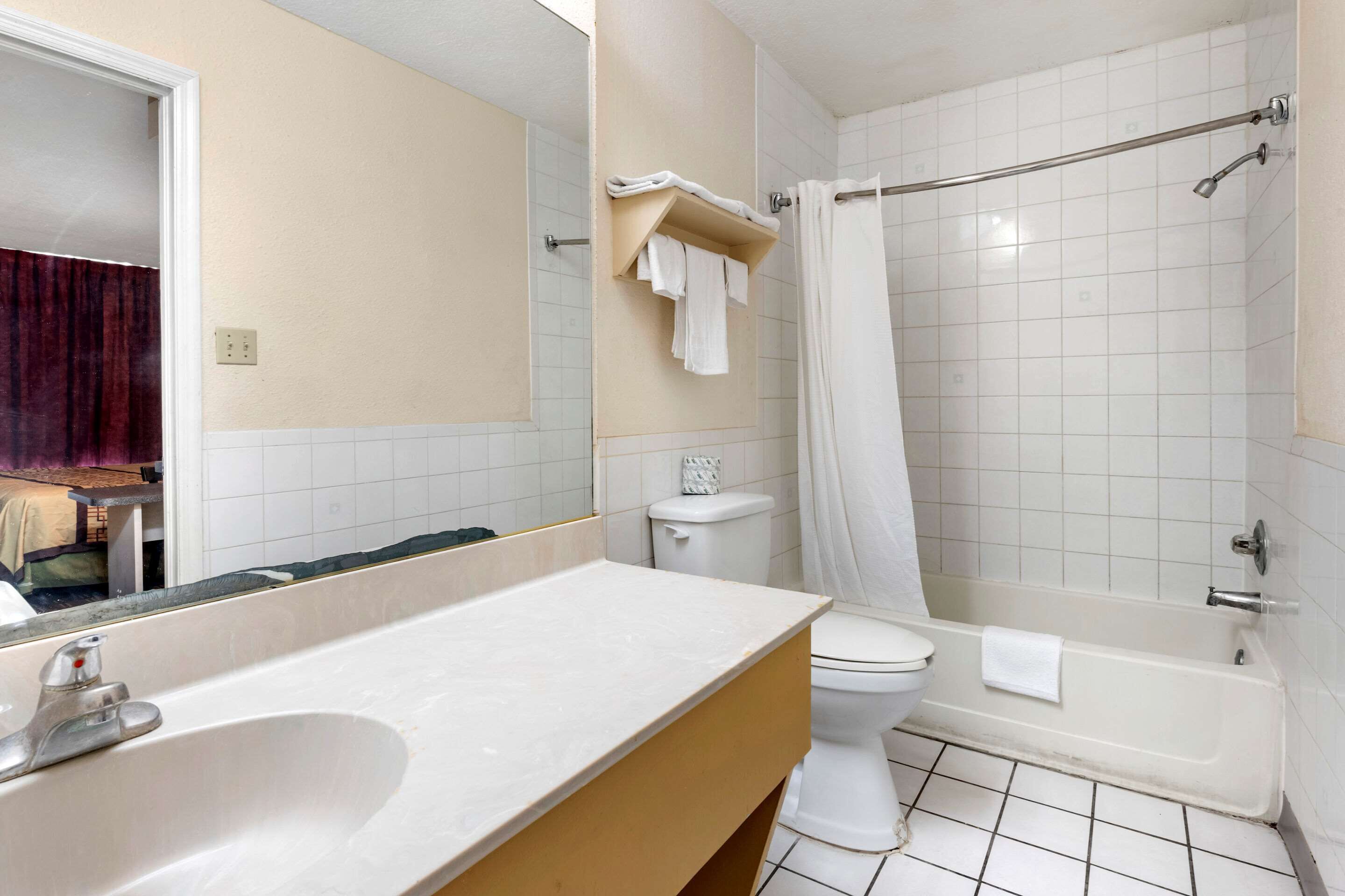 A bathroom with a sink, toilet, and bathtub.