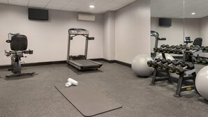 A gym with exercise equipment including a treadmill, elliptical, dumbbells, and exercise balls. - Holiday Inn Philadelphia Arpt-Stadium Area by IHG (Philadelphia)