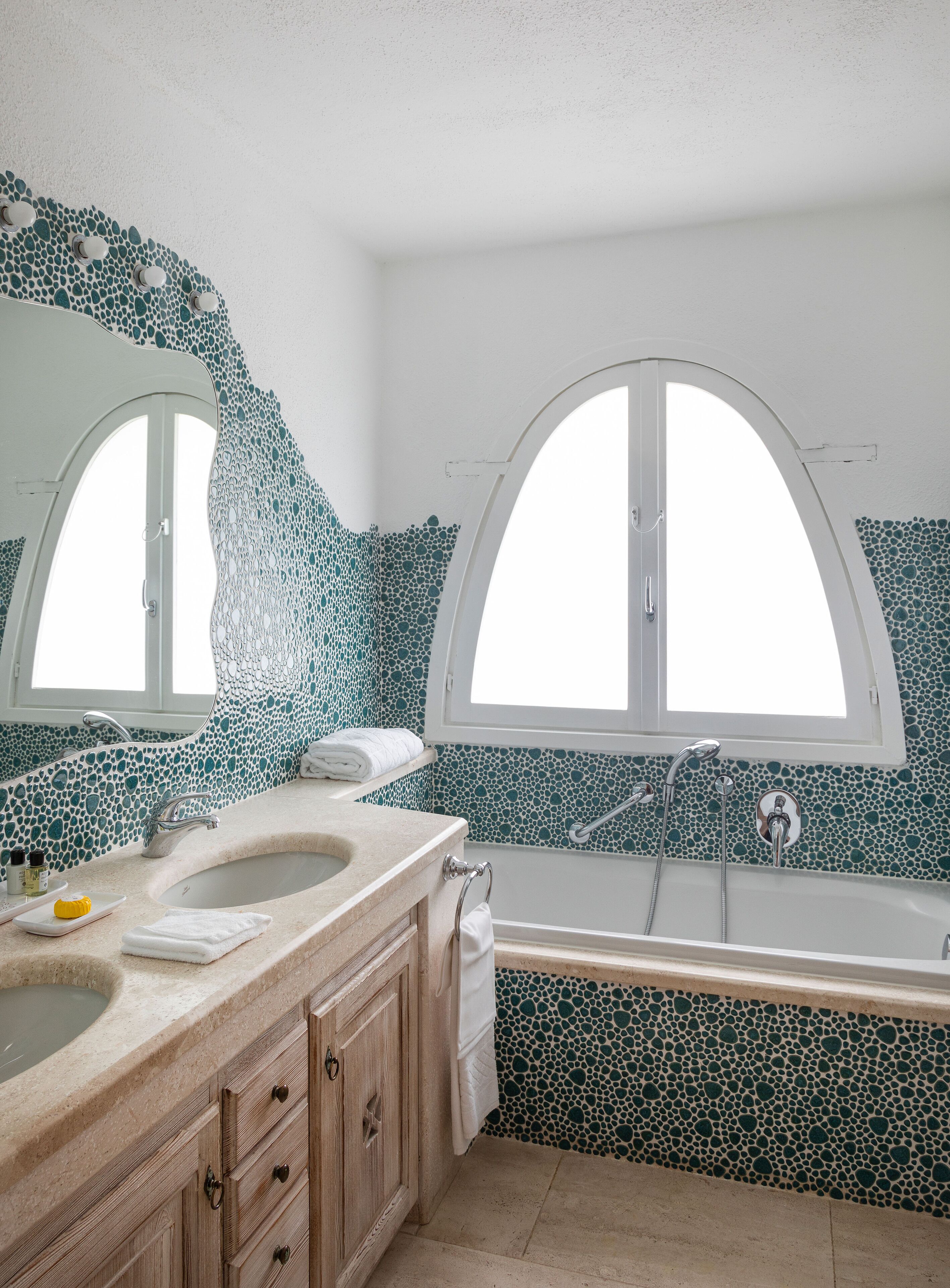 A bathroom with a freestanding bathtub, a vanity with a sink, and a large mirror.