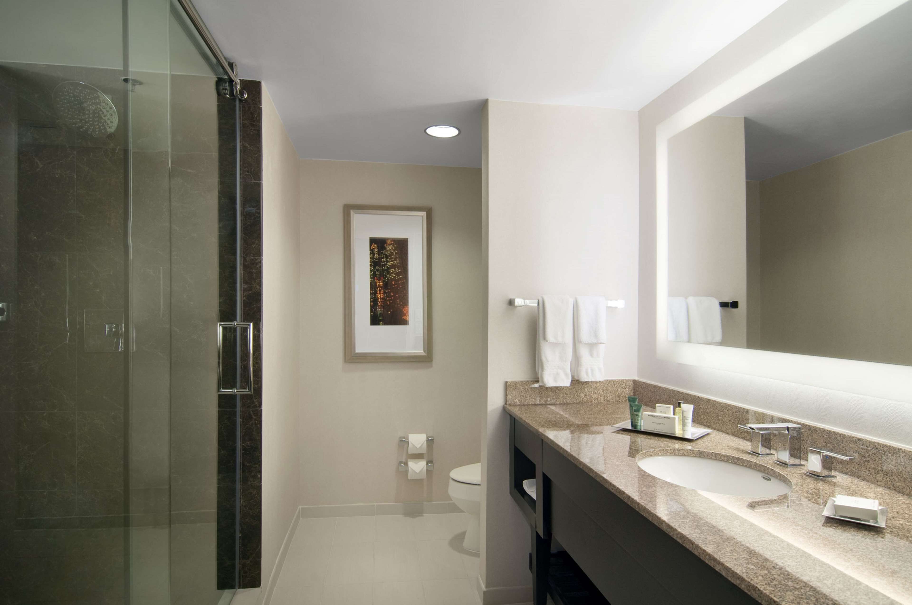 junior suite, one king bed | bathroom | combined shower/bathtub, designer toiletries, hair dryer, towels