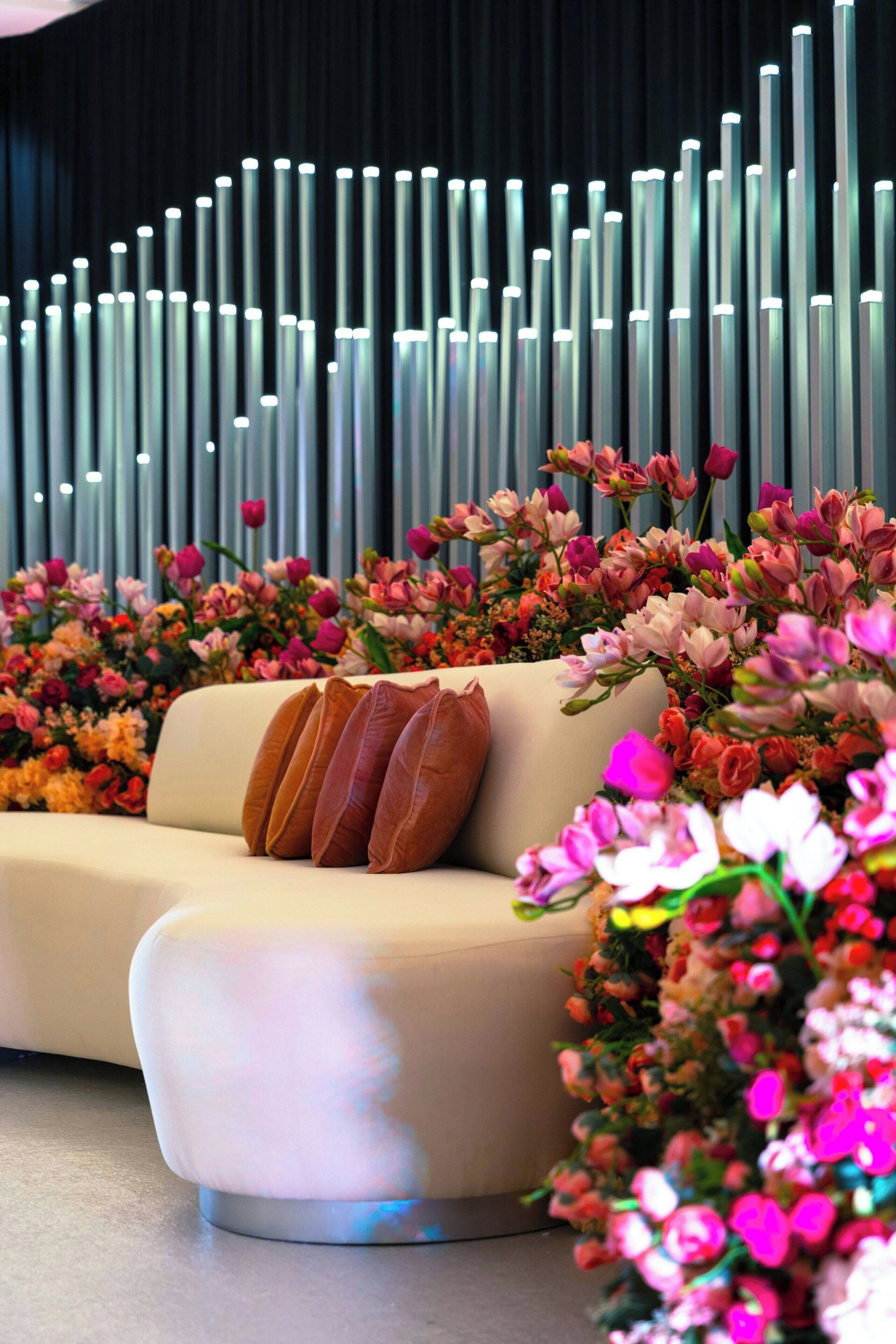 A modern interior with a sofa and decorative flowers.