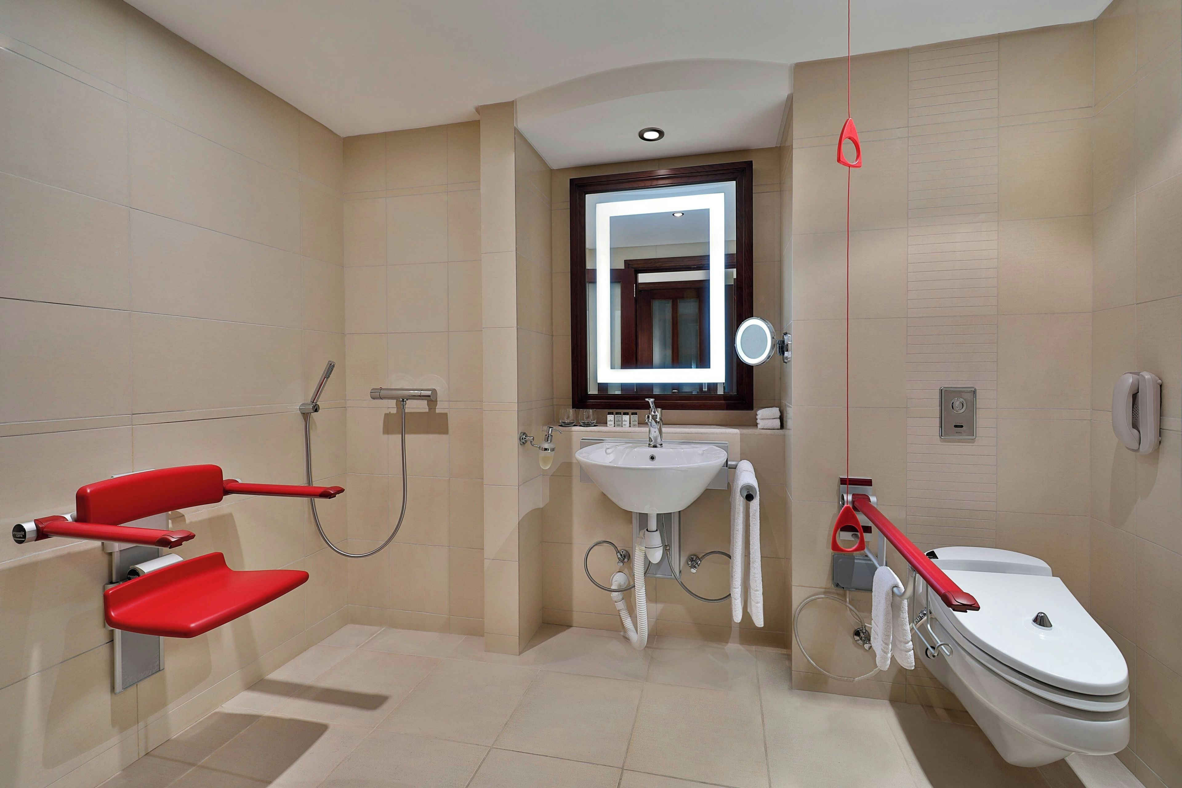 A modern bathroom with a shower, toilet, and sink.
