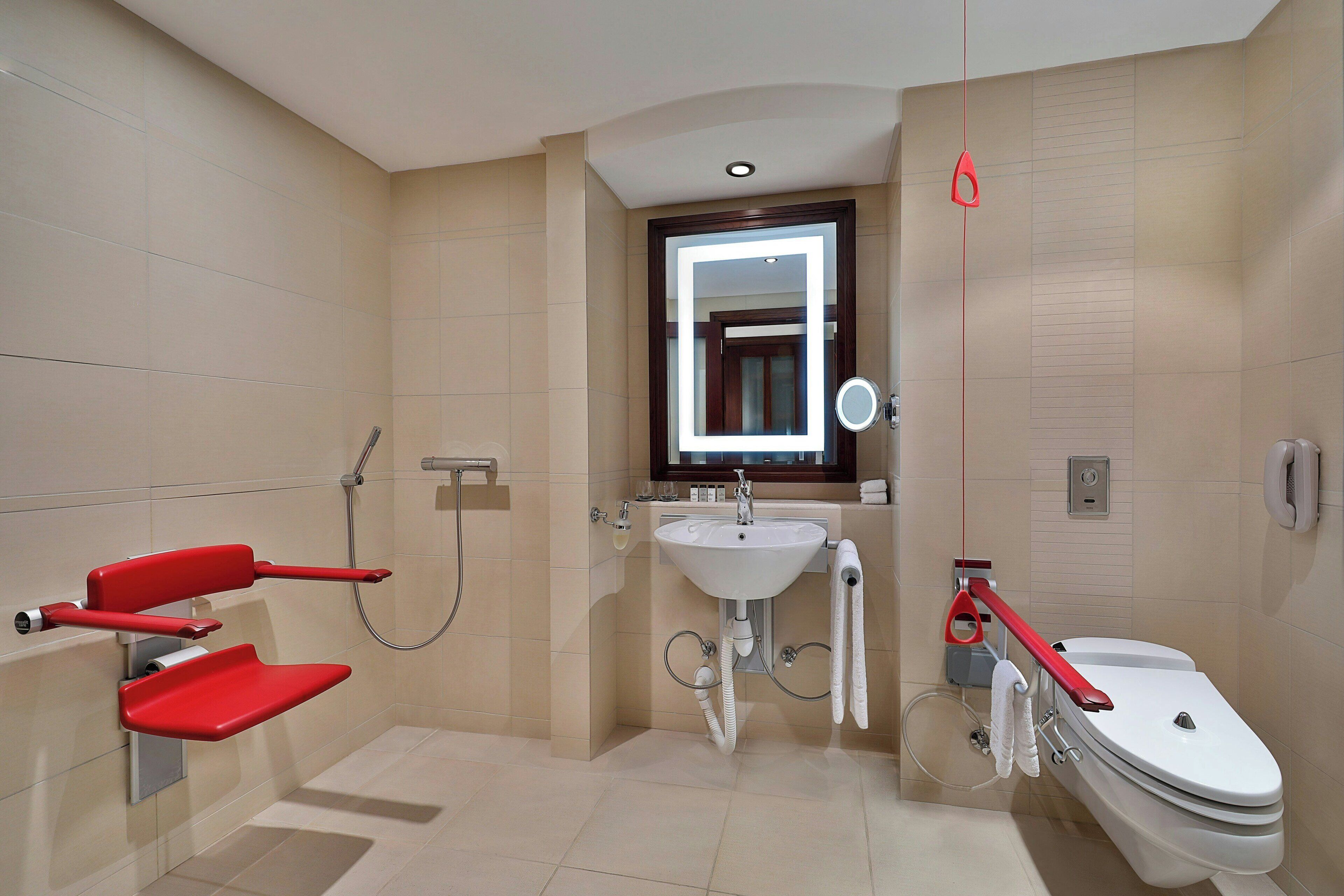 A modern bathroom with a toilet, sink, and shower.