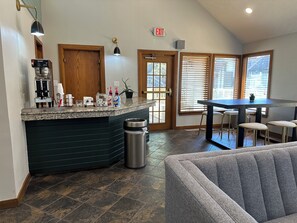 Enjoy a convenient coffee station and comfortable seating area in this well-equipped kitchen.