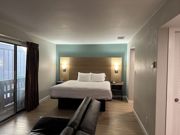 Relax in a stylish room with a large bed, two bedside tables, and a comfortable sofa.