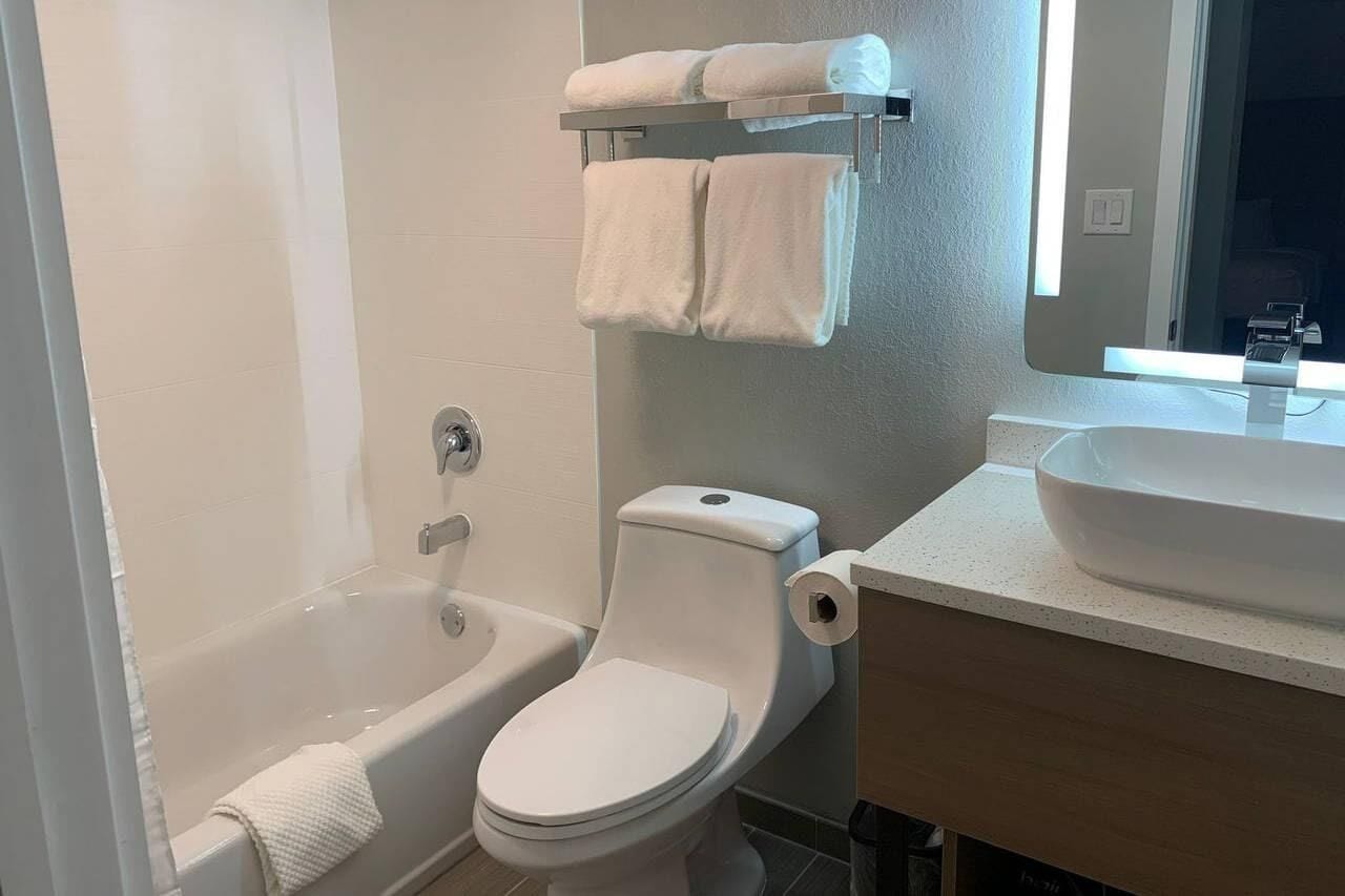 A bathroom with a bathtub, toilet, and a sink.