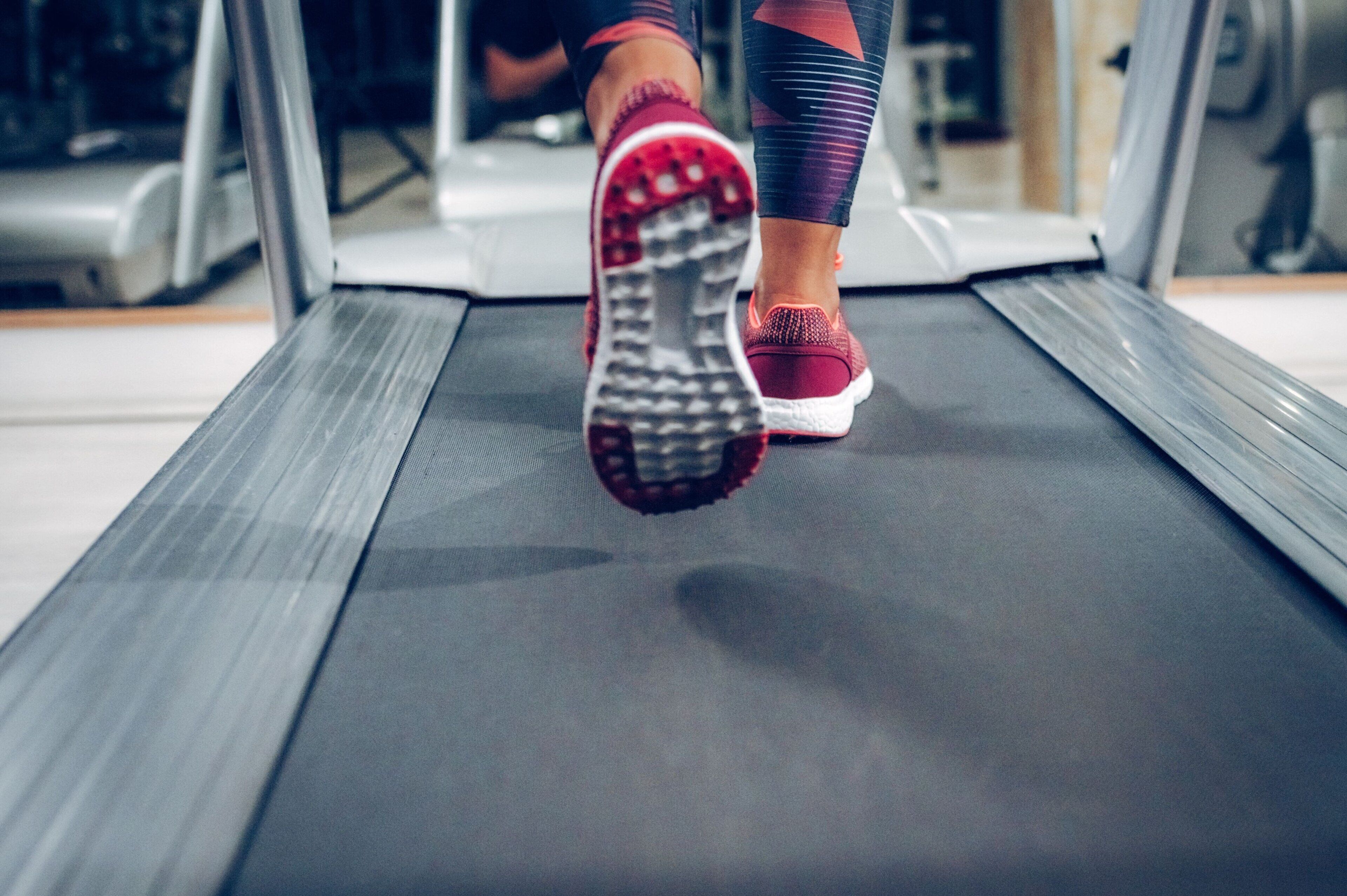 A close-up of a treadmill with a person using it.