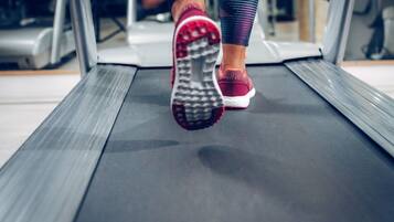A close-up of a treadmill with a person using it.