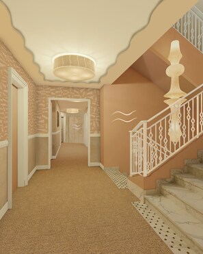 Staircase leads to a spacious area with a patterned carpet and textured walls.