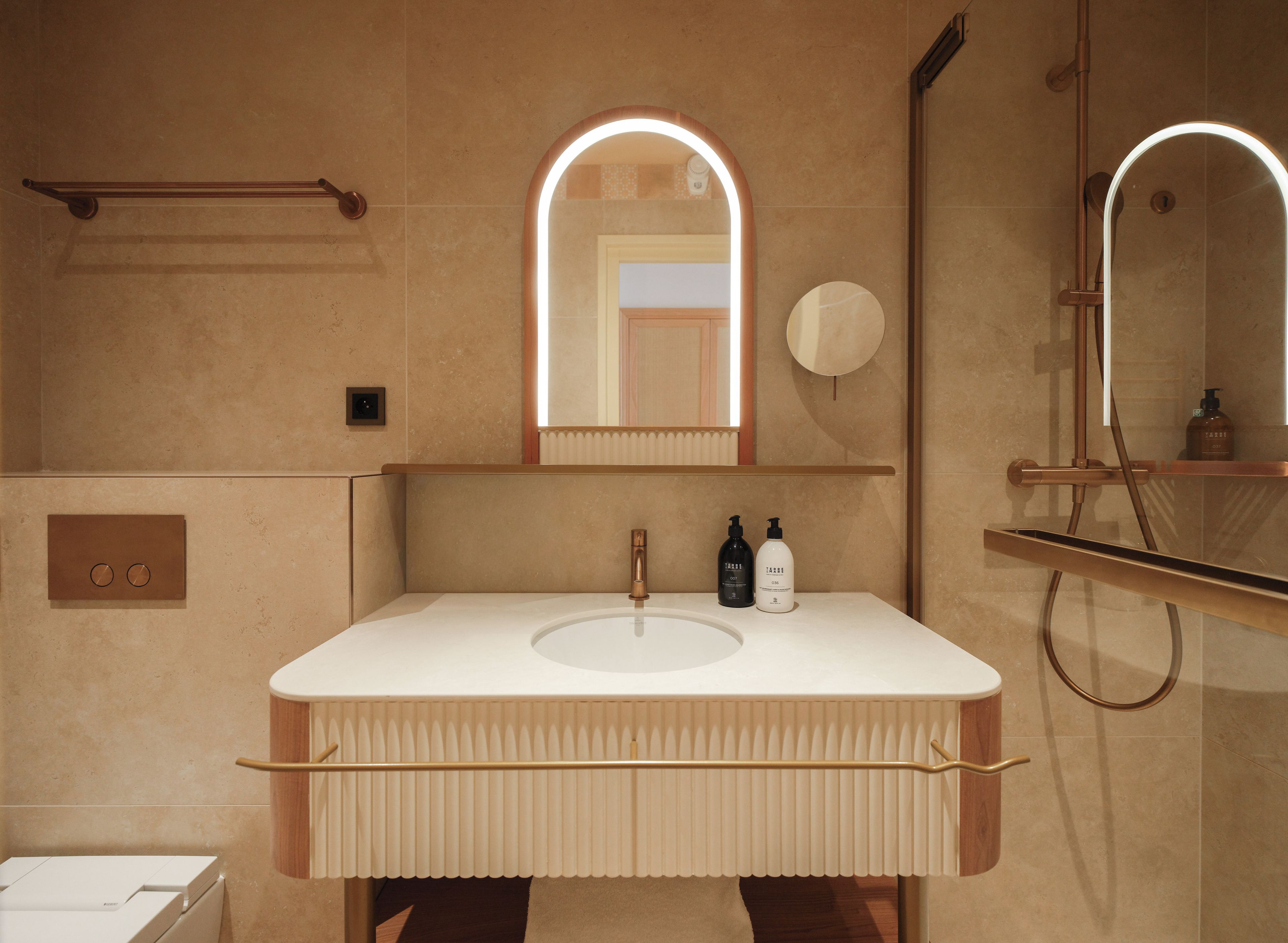 Ein modernes Badezimmer mit einem großen Spiegel, einem Waschbecken und einem Handtuchhalter.