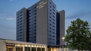 A modern hotel building with a prominent sign reading 'HOTEL DOUBLETREE by Hilton.' - DoubleTree by Hilton Pointe Claire Montreal Airport West (Pointe Claire)