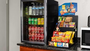 A vending machine stocked with various beverages and snacks, including soda, water, and chips. - Travelodge by Wyndham Banning CA Near Casino/Outlet Mall (Banning)