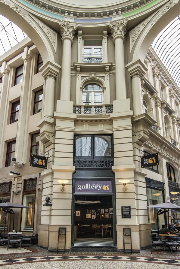 Experience the grandeur of Gallery 61, a historic building with a classical facade, ornate columns, and large windows.