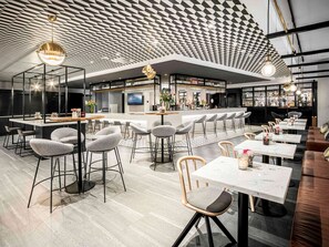 Enjoy a drink at the bar, where you can watch the news on the TV screen.