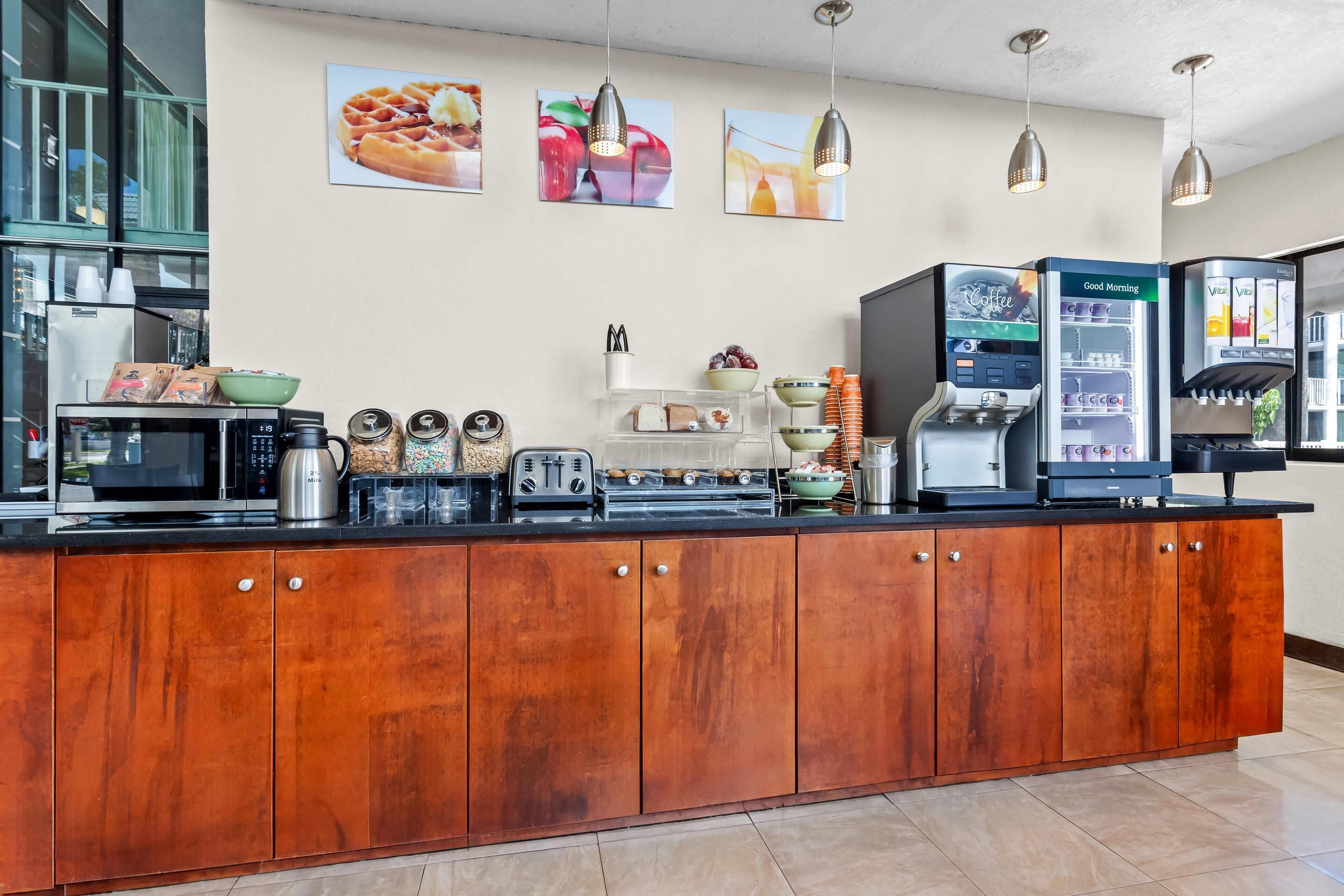 A kitchen area with a coffee machine, toaster, and various food items on the counter.