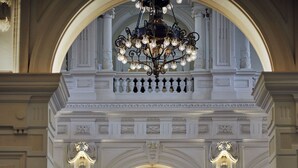 A grand lobby with an ornate chandelier, a large floral arrangement, and a clock on the wall. - InterContinental Amstel Amsterdam by IHG (Amsterdam)