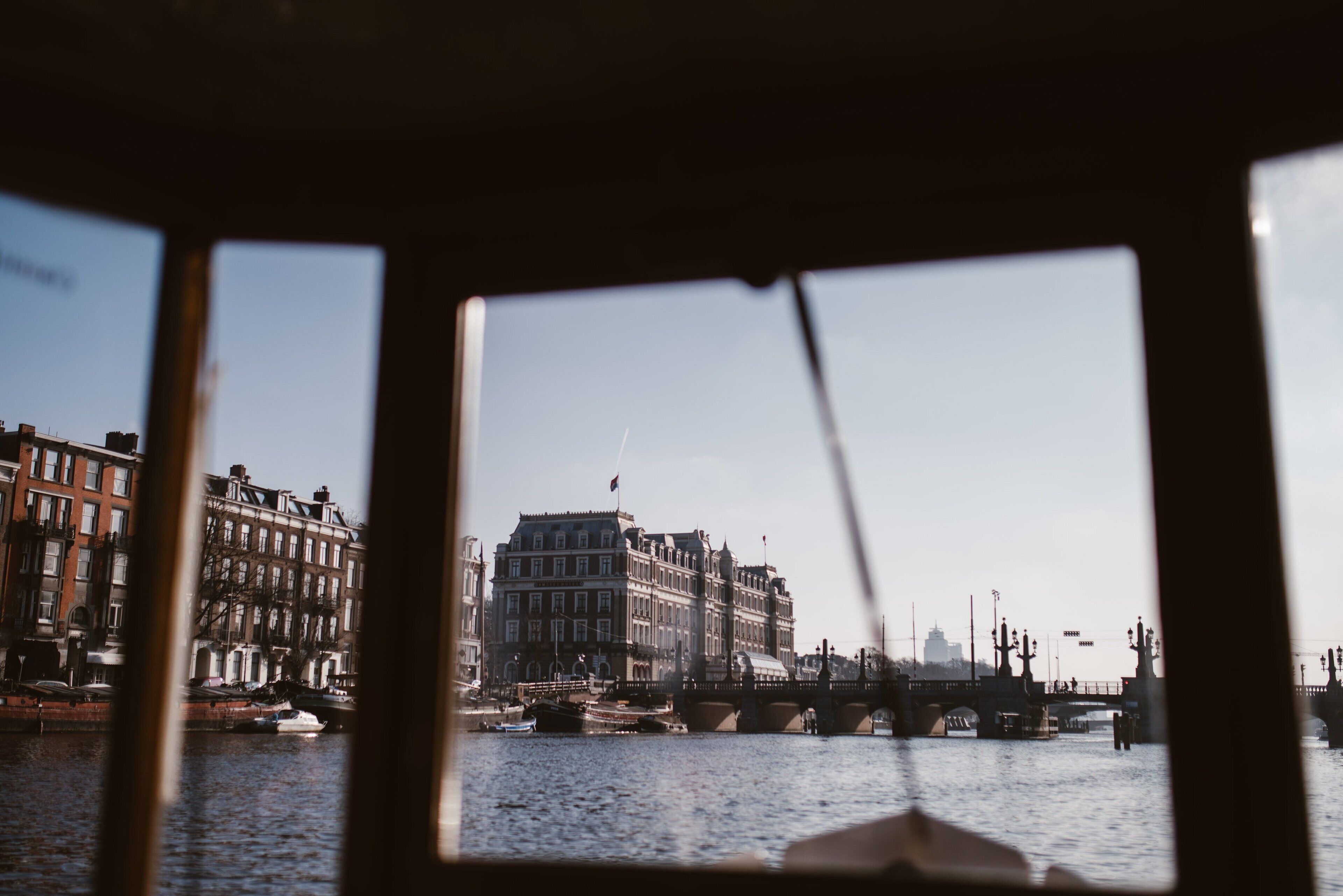 A view of a river with buildings and a bridge.
