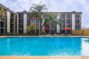Seasonal outdoor pool, open 8 AM to 8:00 PM, pool umbrellas