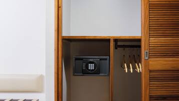 A wooden closet with a built-in safe and a coat rack.