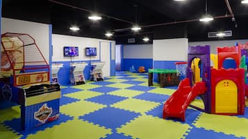 Kids can play and climb on the basketball hoop, slide, and climbing wall in this indoor play area.