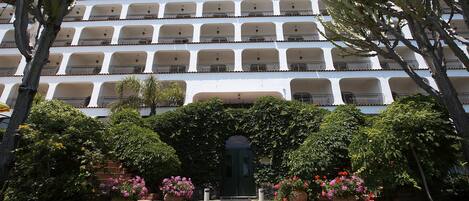A multi-story building with balconies and a central entrance.