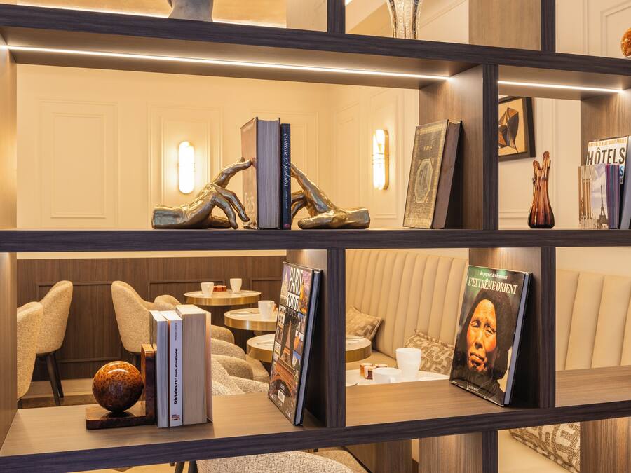 A modern interior with a wooden bookshelf, a sofa, and a coffee table.